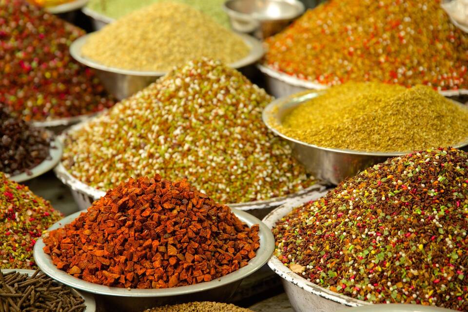 Various piles of spices in metal bowls.