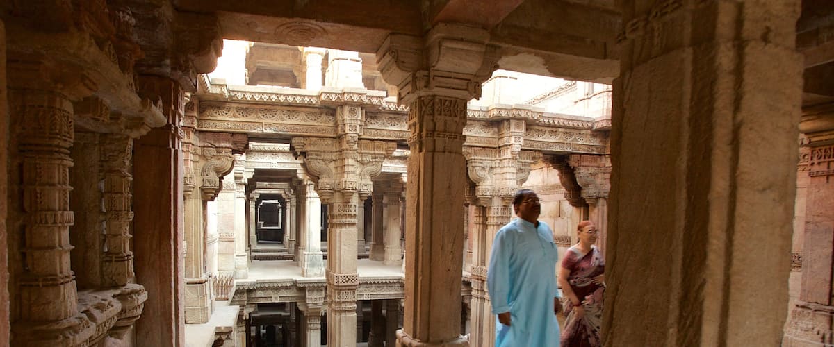 An ancient stone structure with intricate carvings and a central open space.