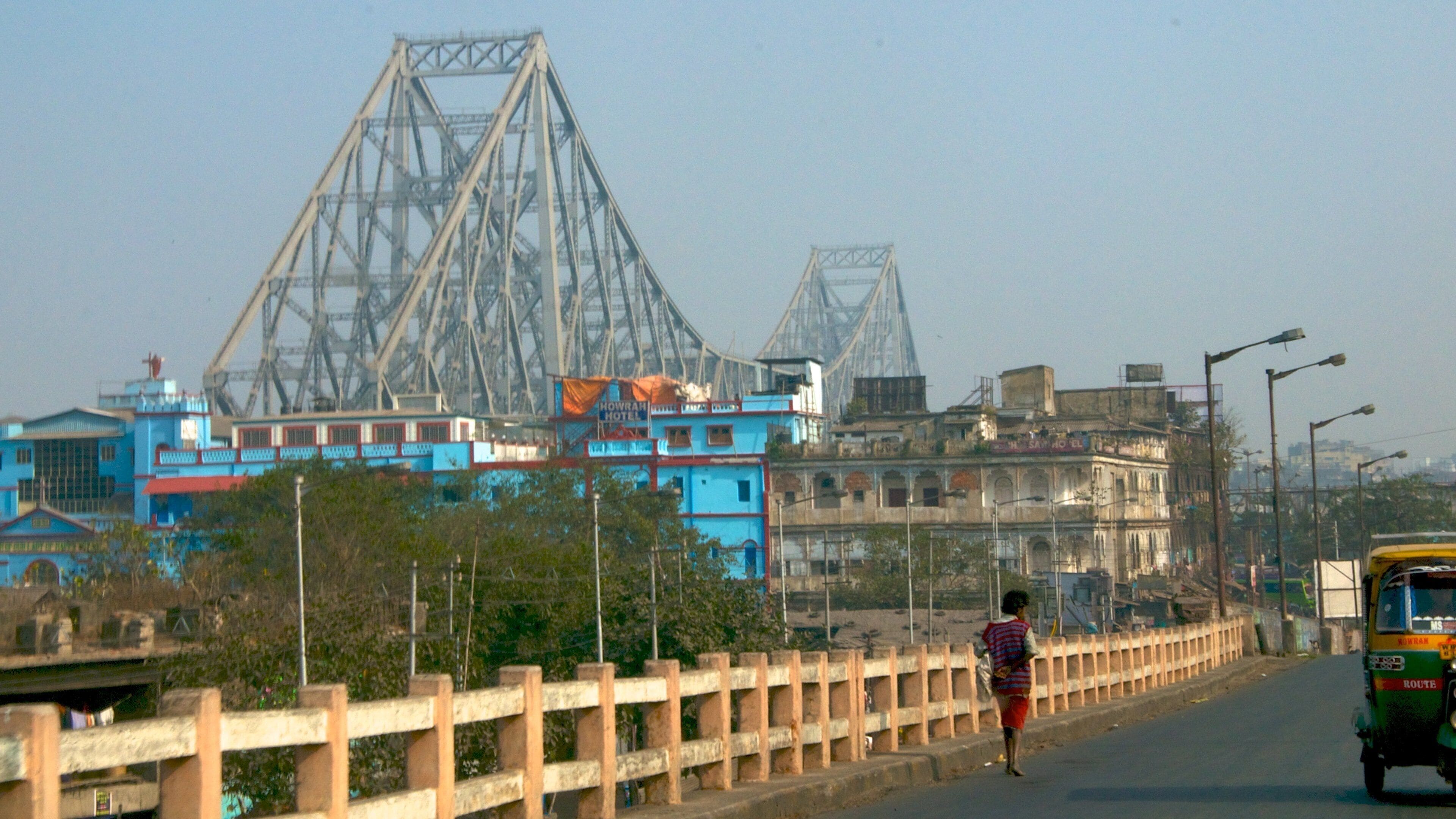 Howrah Bridge which includes street scenes, a city and a bridge