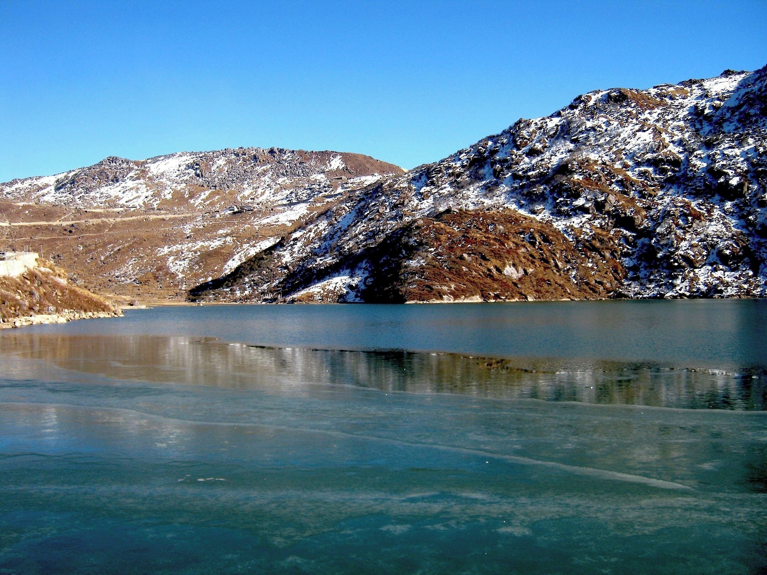 #Waterlust #aquatrove
Lake Changu or Tsongmo is a glacial lake 40 kilometres away from Gangtok.I went there in December…peak of winters..it was freezing cold in gangtok only so you can imagine at an elevation of 3780m.When i saw this mesmerising view of the half frozen lake,my body temp was back to normal due to sudden excitement.The sun rays on the snow and water made them sparkle.It was beautiful.A camera can't capture 20% also of what your actual eyes see.