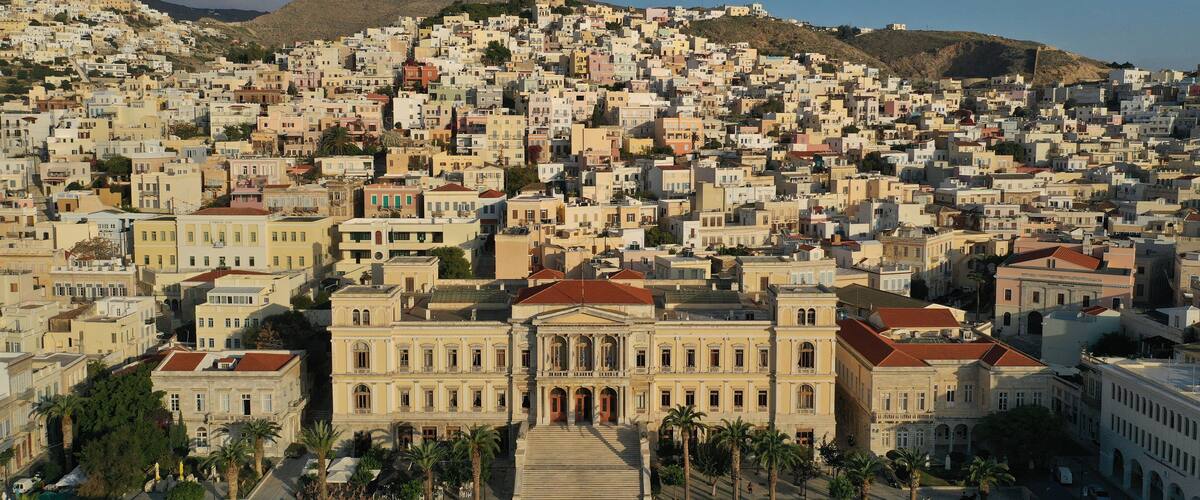 Aerial drone photo of iconic landmark neoclassical city hall building in main town of Syros or Siros island - Miaouli square, Ermoupolis, Cyclades, Greece