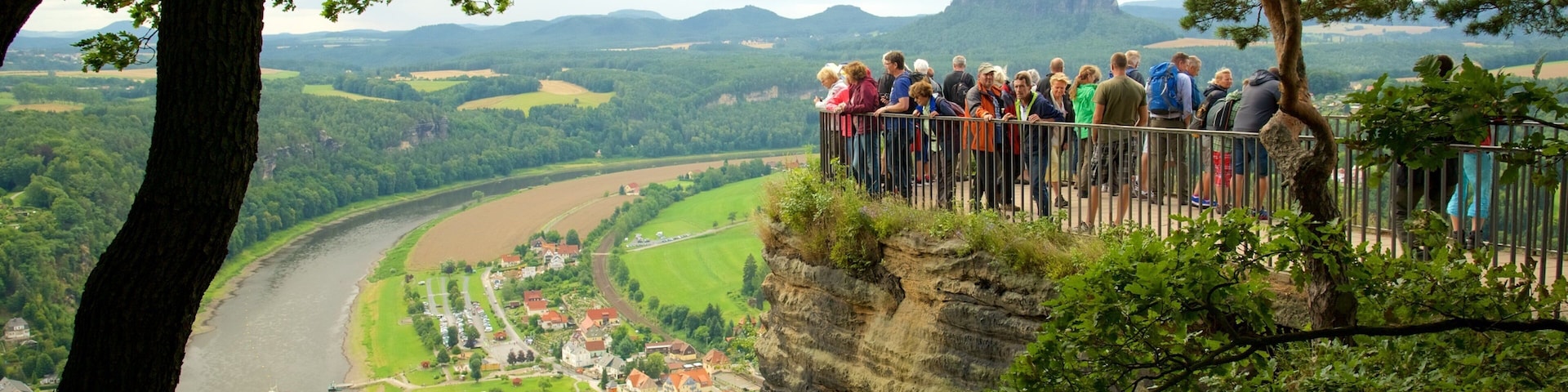 Saxon Switzerland National Park which includes views and a river or creek as well as a large group of people