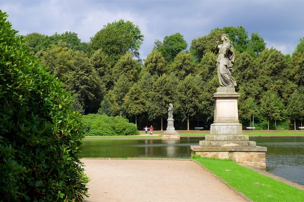 Bremen Buergerpark which includes a lake or waterhole, a park and a statue or sculpture