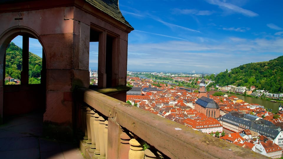 A historic stone bridge with arches overlooking a river and a cityscape with red-roofed buildings.