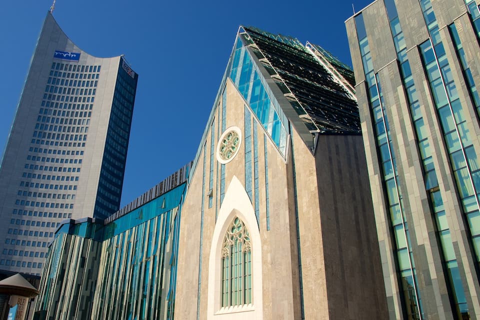 A modern building with a curved roof and a large clock tower.
