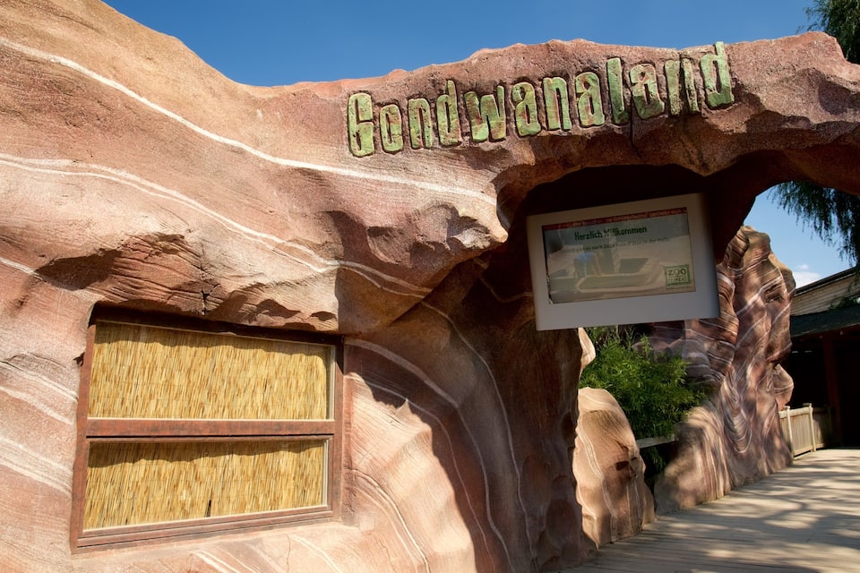 A rock formation with the text 'Gondwana Land' and a sign with German text.