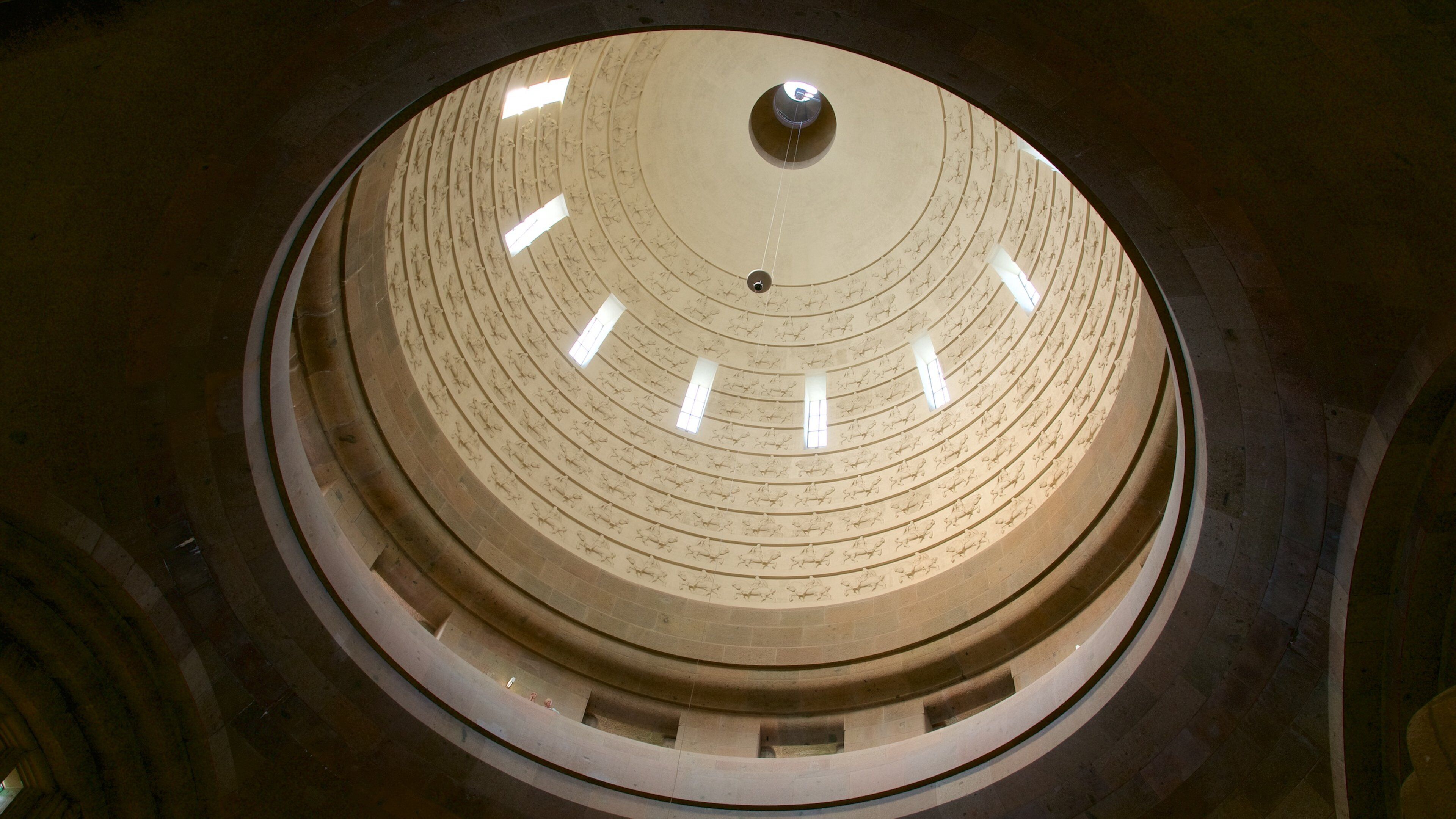 A circular architectural structure with concentric rings and inscriptions.