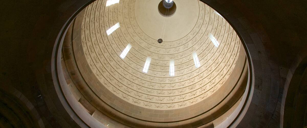 A circular architectural structure with concentric rings and inscriptions.