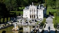 Linderhof Palace featuring heritage architecture, a fountain and chateau or palace