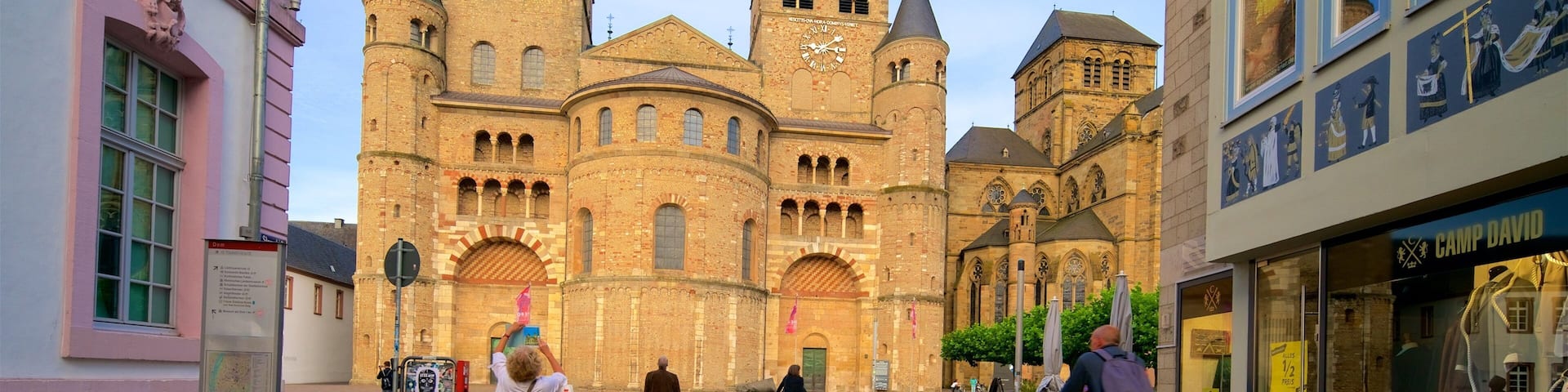 A historic church with two towers and a large clock.