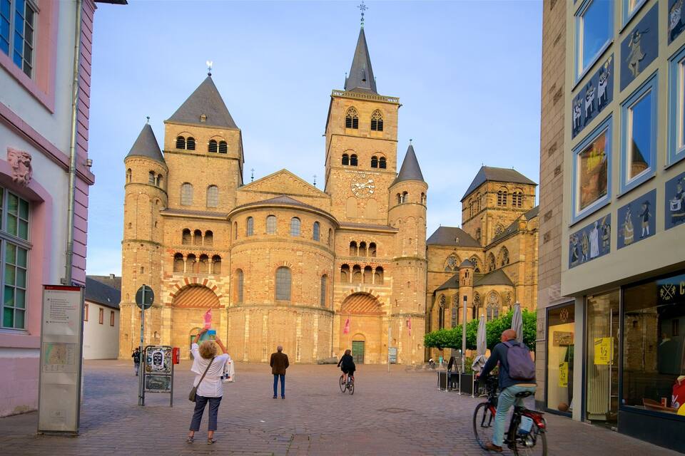 A historic church with two towers and a large clock.