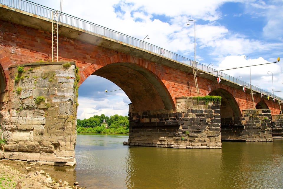 A stone bridge with multiple arches over a river.