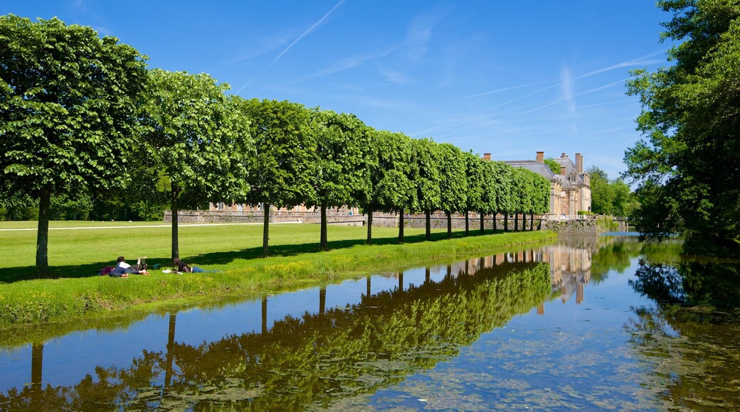 Chateau de la Ferte-St-Aubin which includes a pond and a park