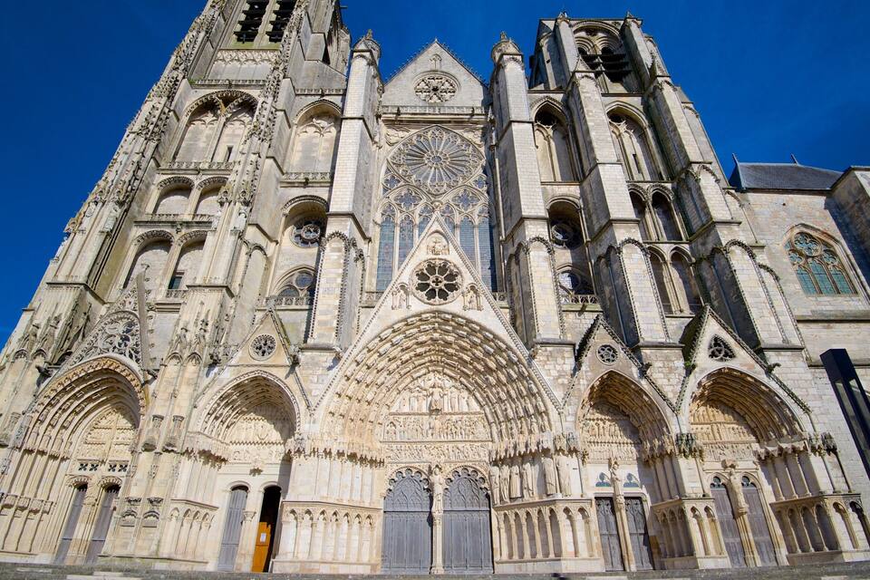 A Gothic cathedral with intricate stone carvings, large rose windows, and pointed arches.