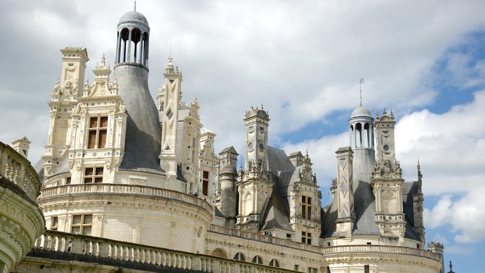 A grand, ornate castle with multiple spires and towers, featuring intricate architectural details and a large dome.
