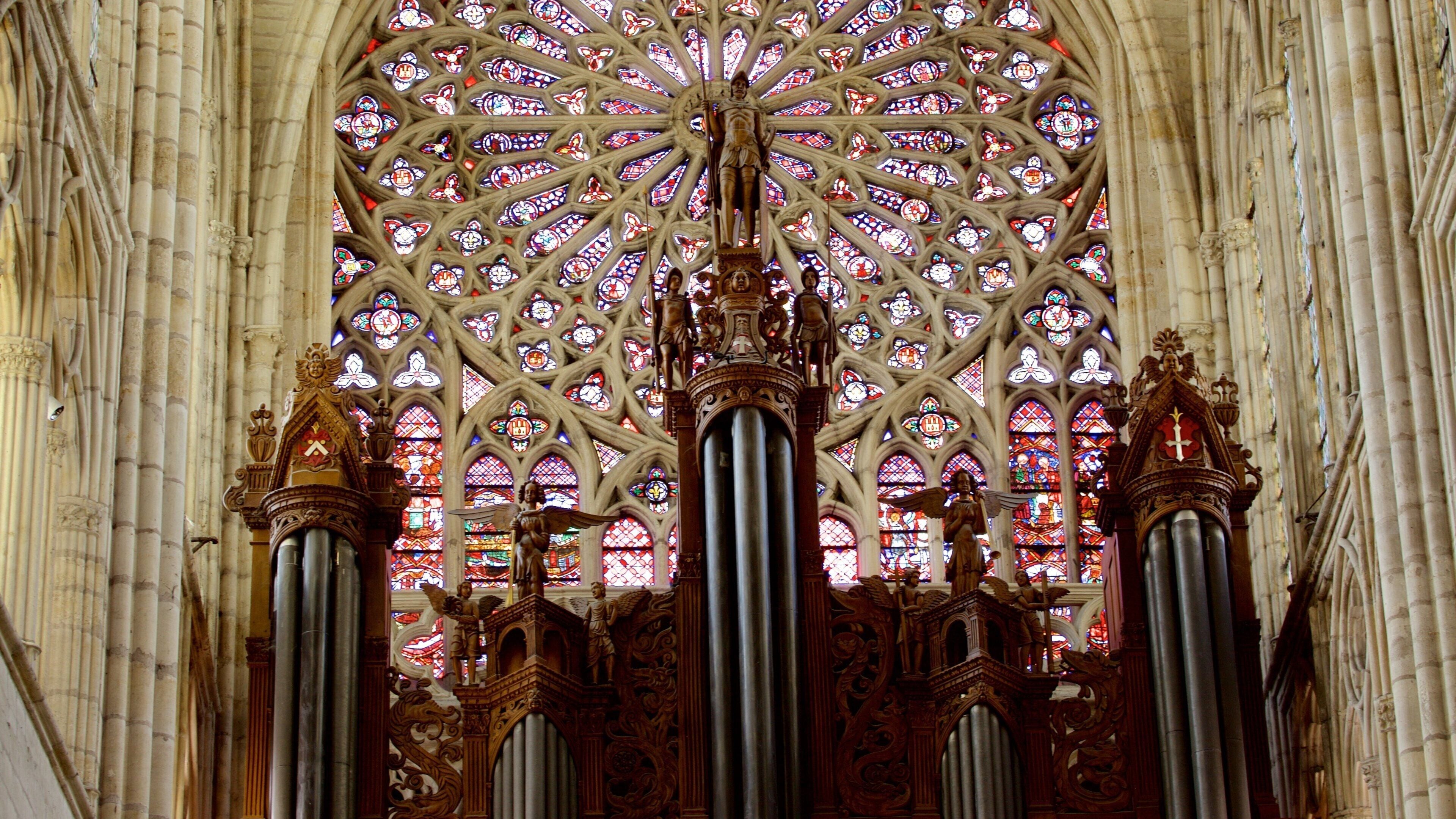 A Gothic cathedral interior with stained glass windows and ornate columns.
