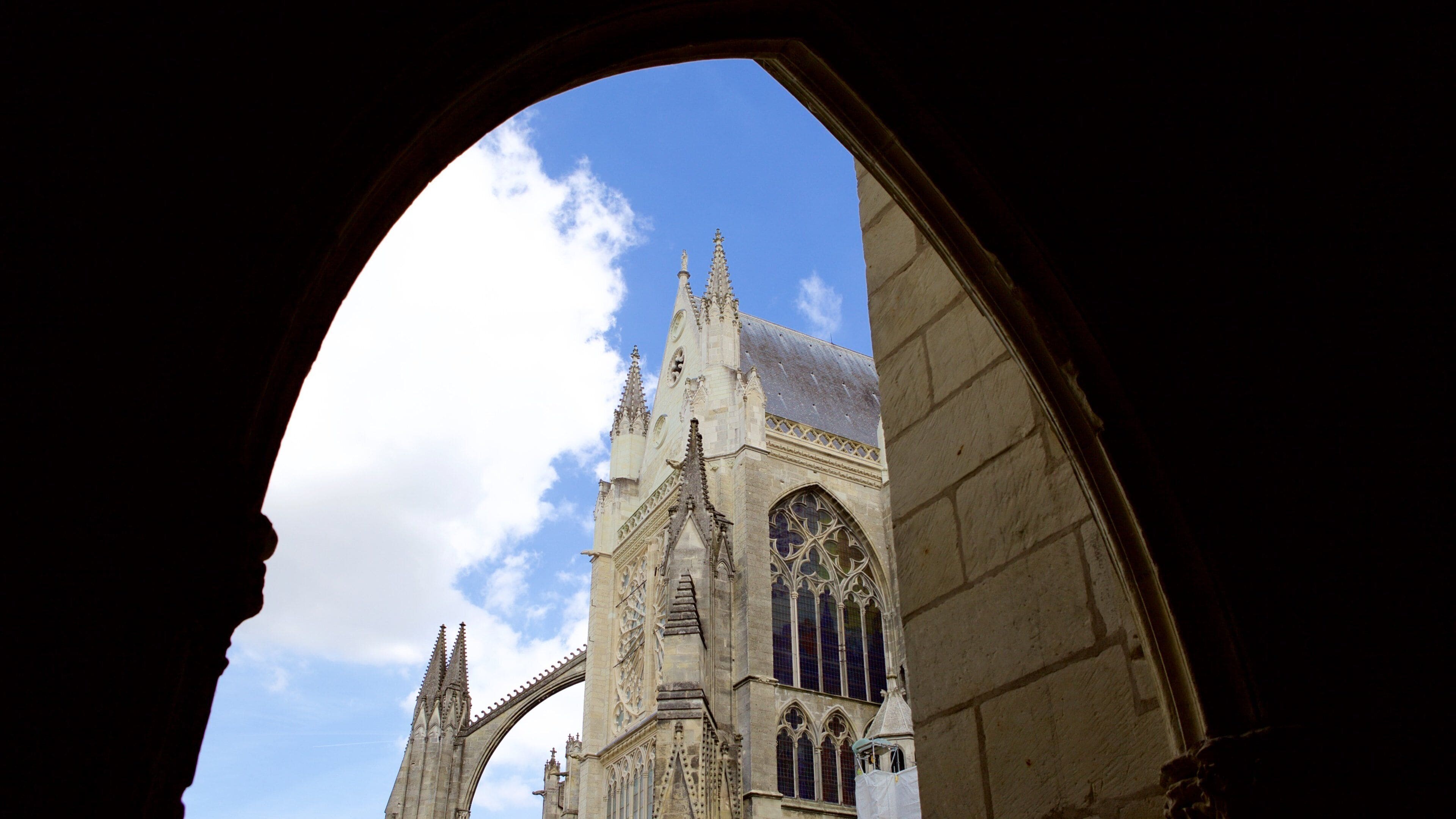 A cathedral with a pointed arch window and a tall spire.