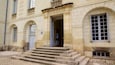 A historic building with a sign reading "MUSEE DES BEAUX-ARTS" and a set of stone steps leading to the entrance.