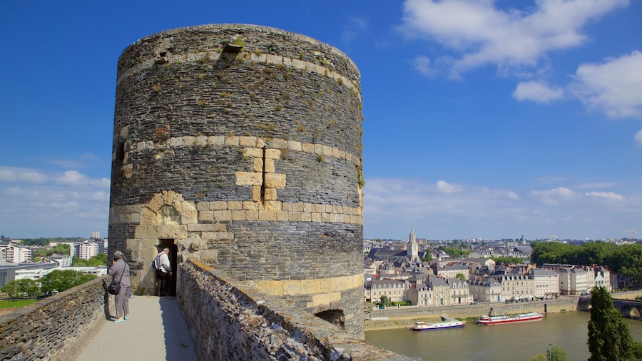 Chateau d\'Angers showing heritage elements, a river or creek and a city