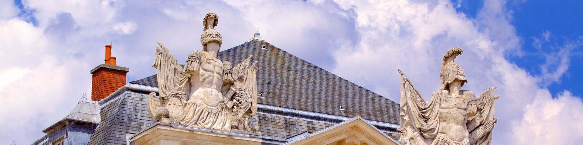 A building with ornate sculptures and classical architecture.