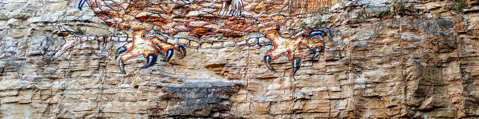 A modern depiction of a mythical Native American dragon on a limestone bluff in Alton, Illinois.