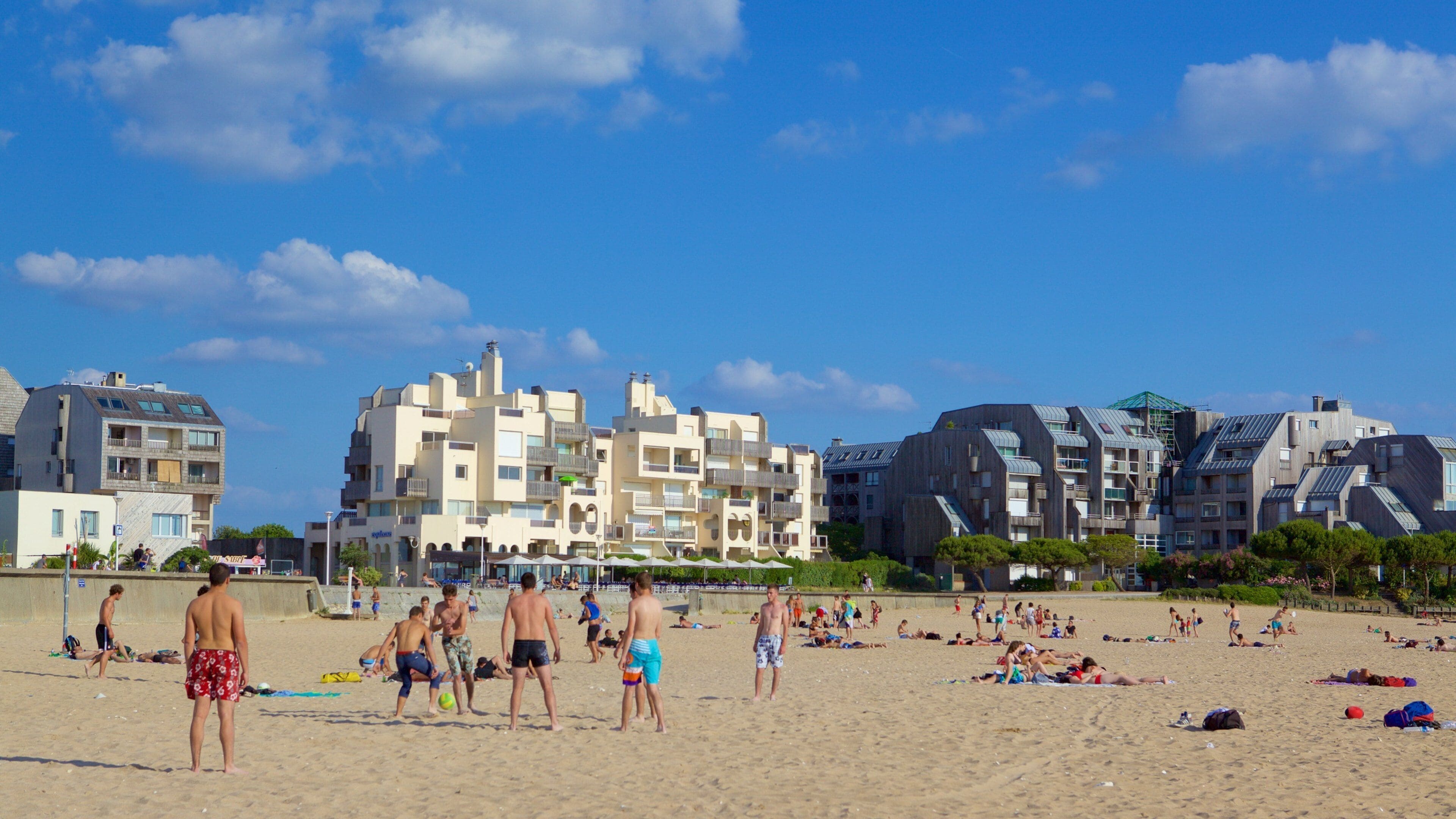 Minimes Beach featuring a sandy beach as well as a large group of people