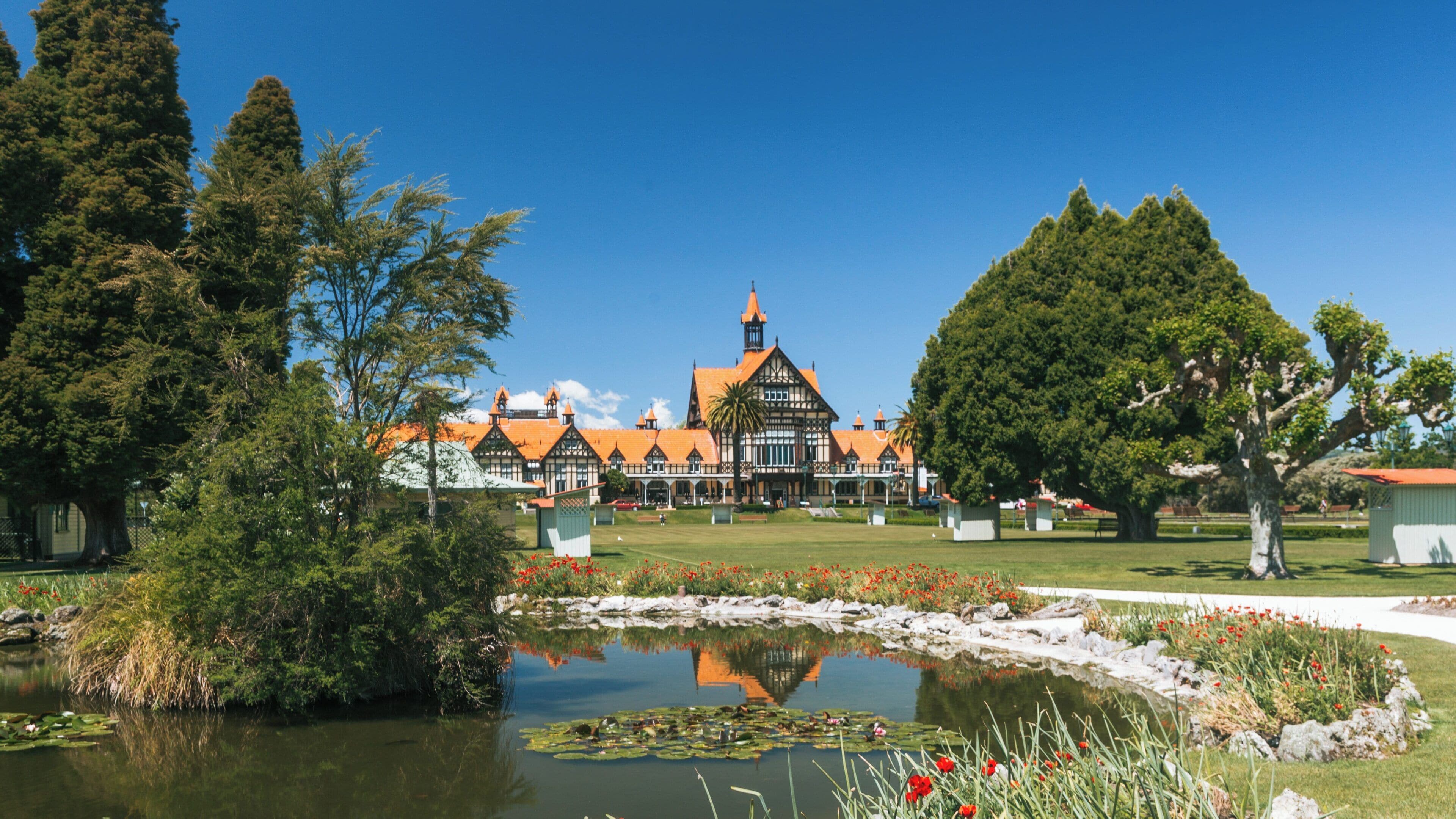 Government Gardens in Rotorua showcasing beautiful landscapes and historic architecture amidst clear blue skies in Bay of Plenty region, New Zealand