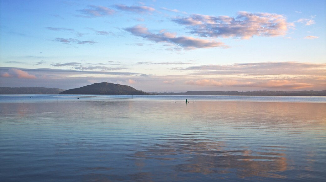 Mokoia Island showing a lake or waterhole and a sunset