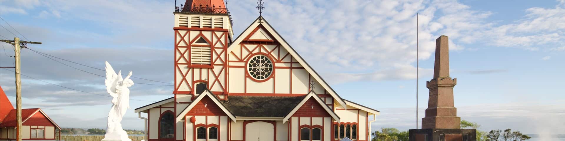 A church with a tall steeple and a large clock.