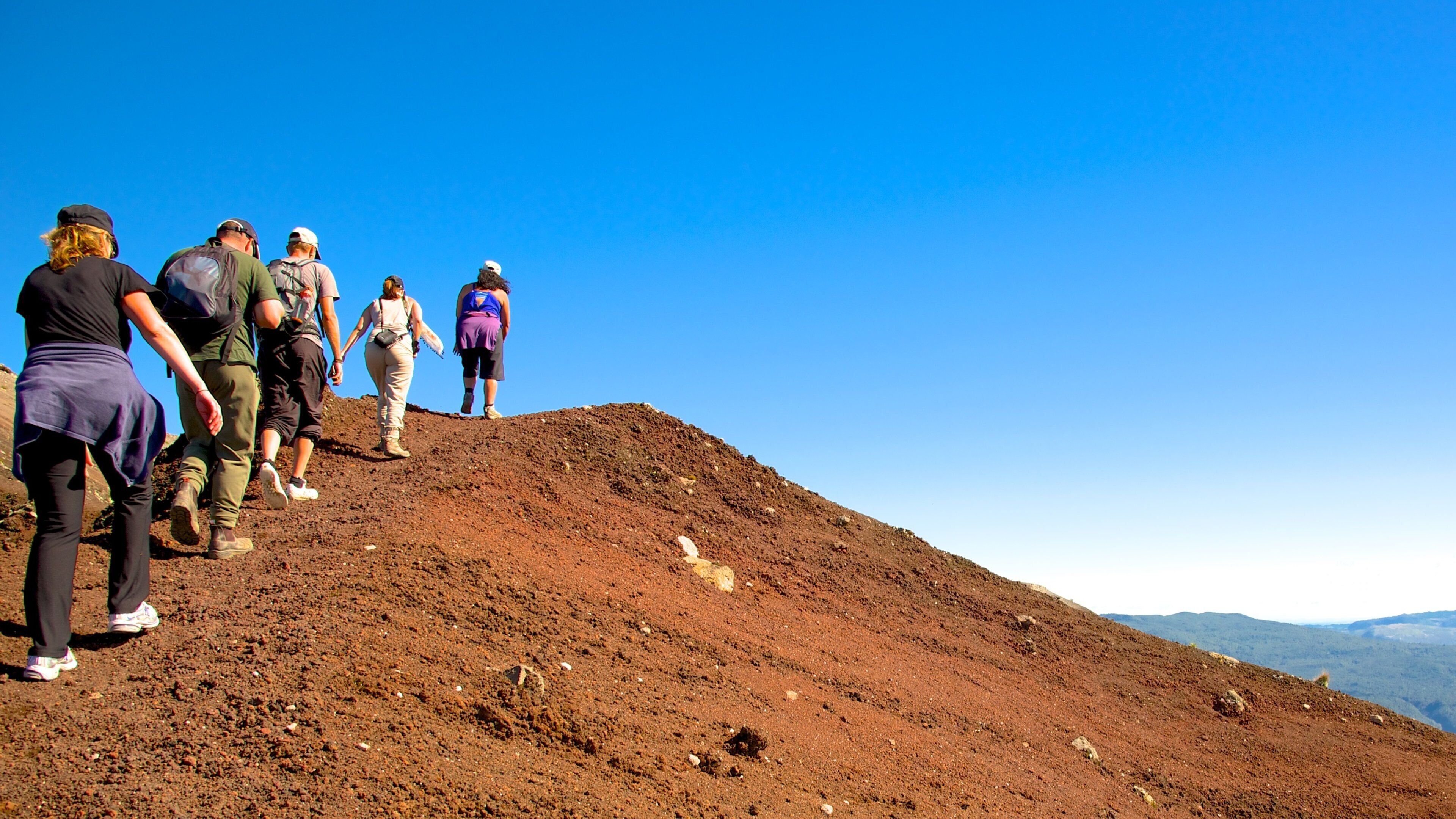 Mount Tarawera which includes tranquil scenes and hiking or walking as well as a small group of people