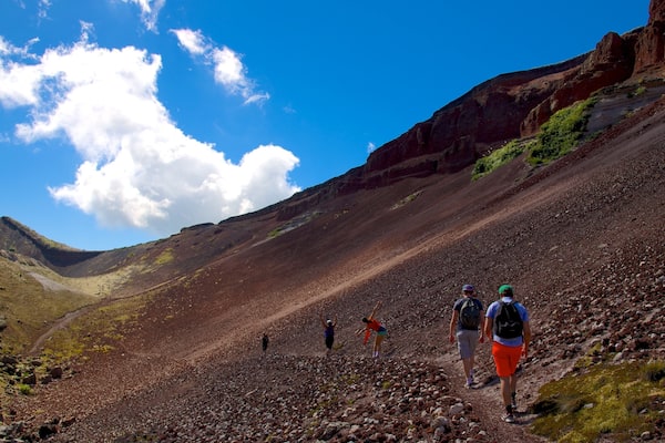 A rocky mountain trail with hikers.