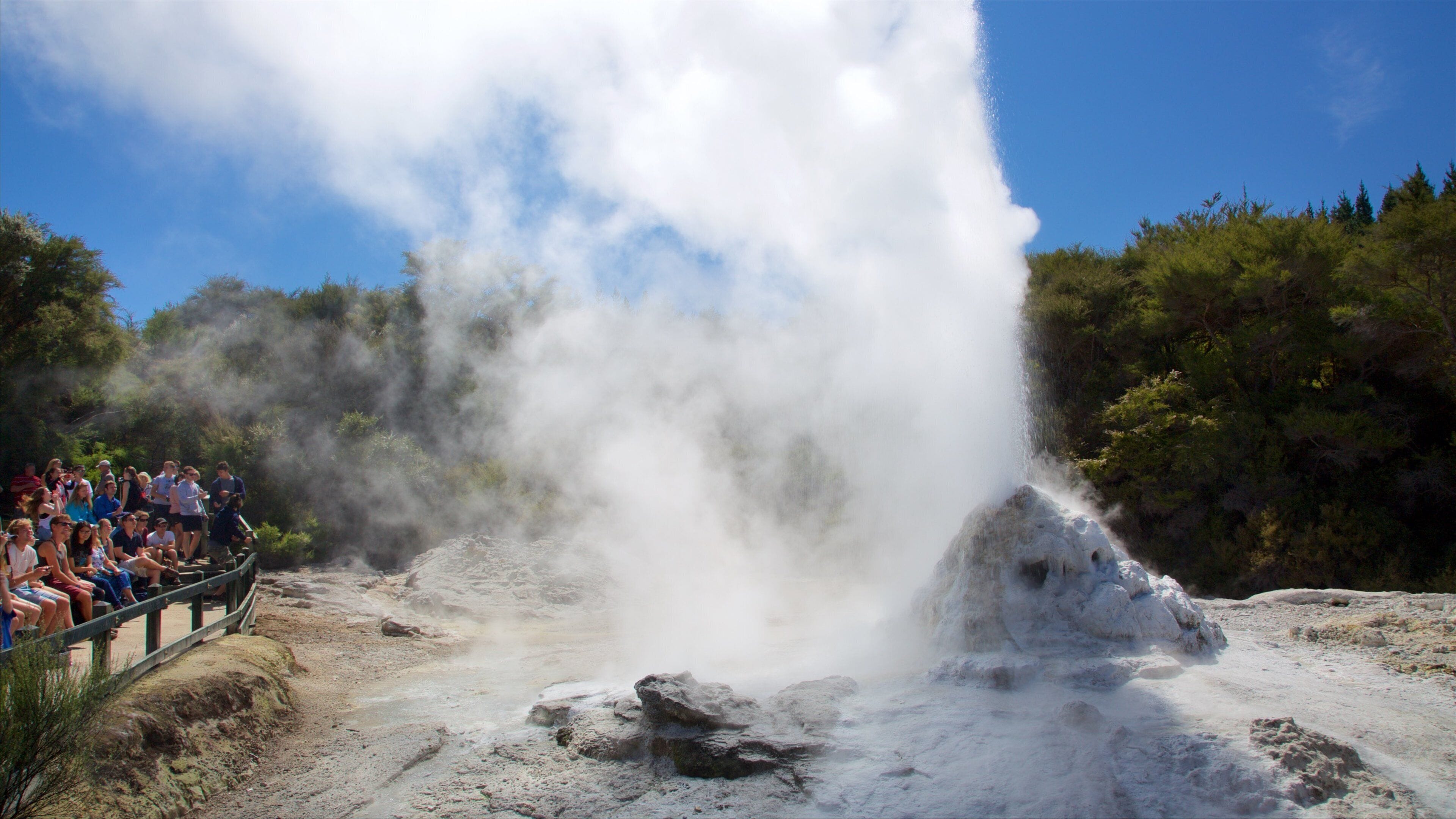 Wai-O-Tapu Thermal Wonderland featuring a hot spring and views as well as a small group of people