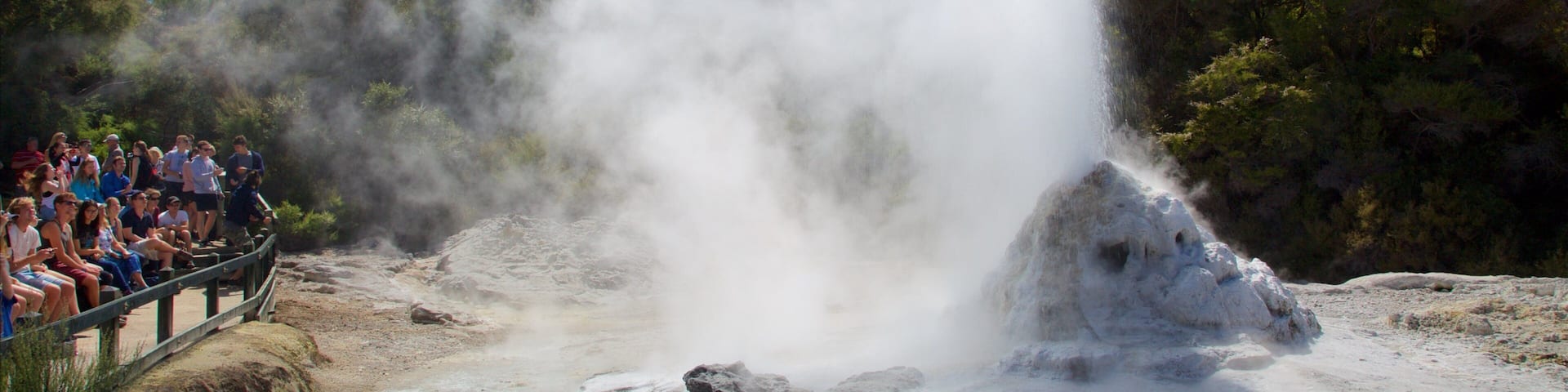Wai-O-Tapu Thermal Wonderland featuring a hot spring and views as well as a small group of people