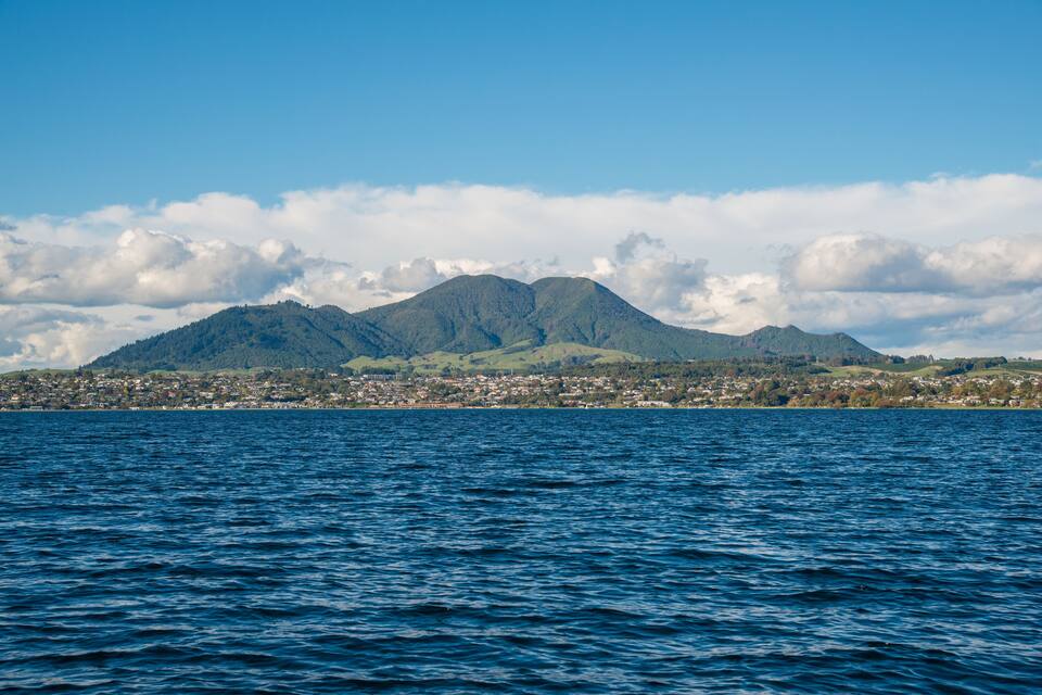 A coastal city with a mountain in the background.