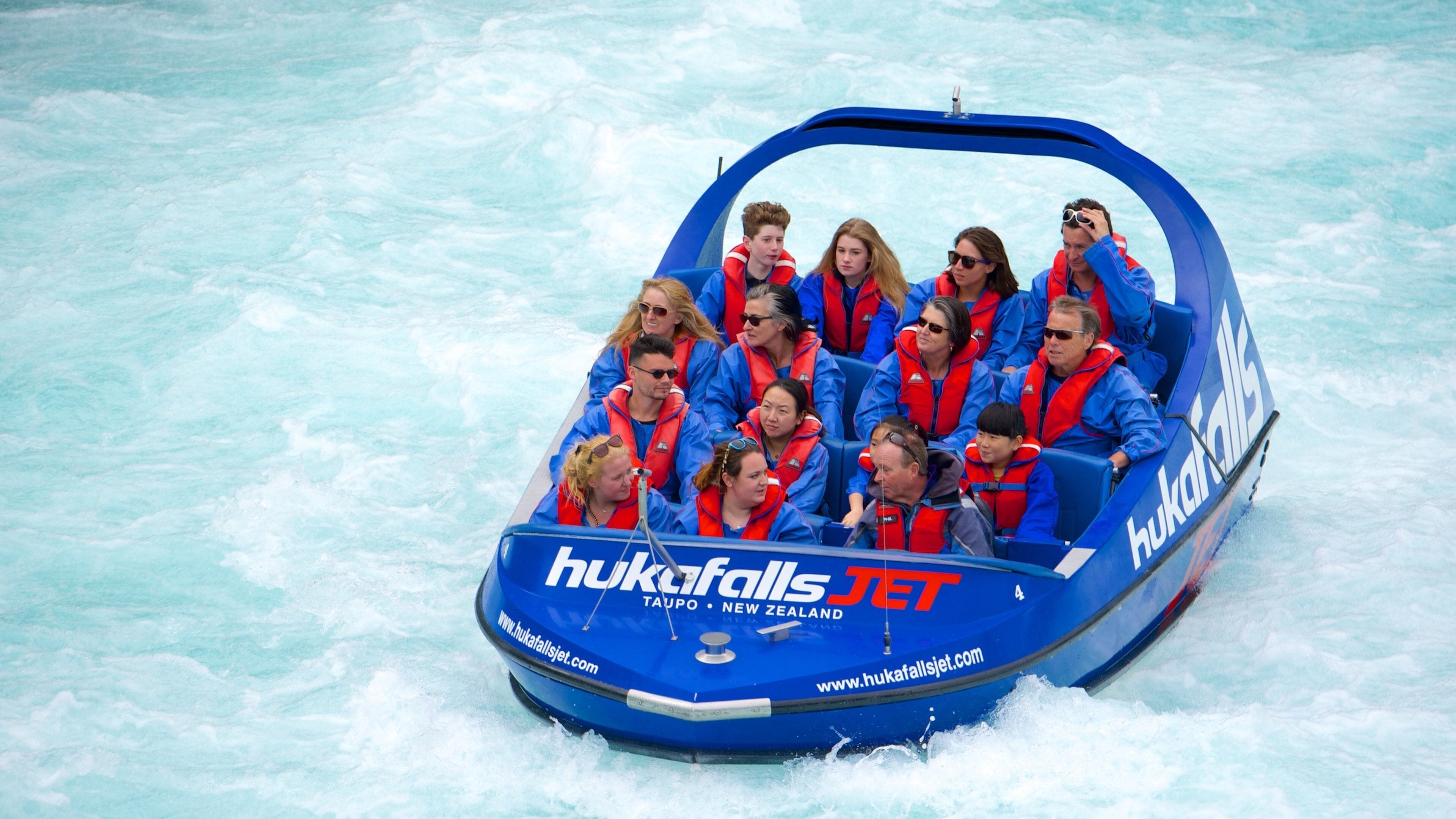 Huka Falls featuring boating as well as a small group of people
