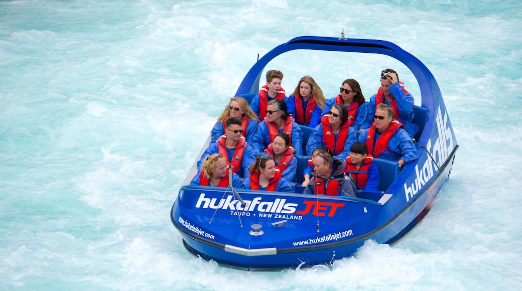 Huka Falls featuring boating as well as a small group of people