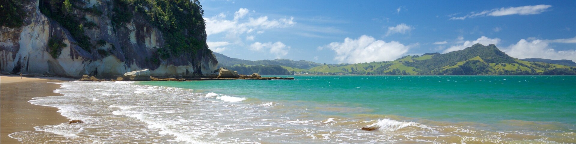Lonely Bay Beach showing rocky coastline, a bay or harbor and a beach