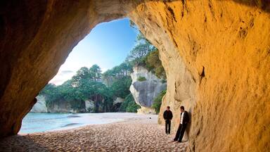 Cathedral Cove Beach which includes a bay or harbour, a beach and rugged coastline