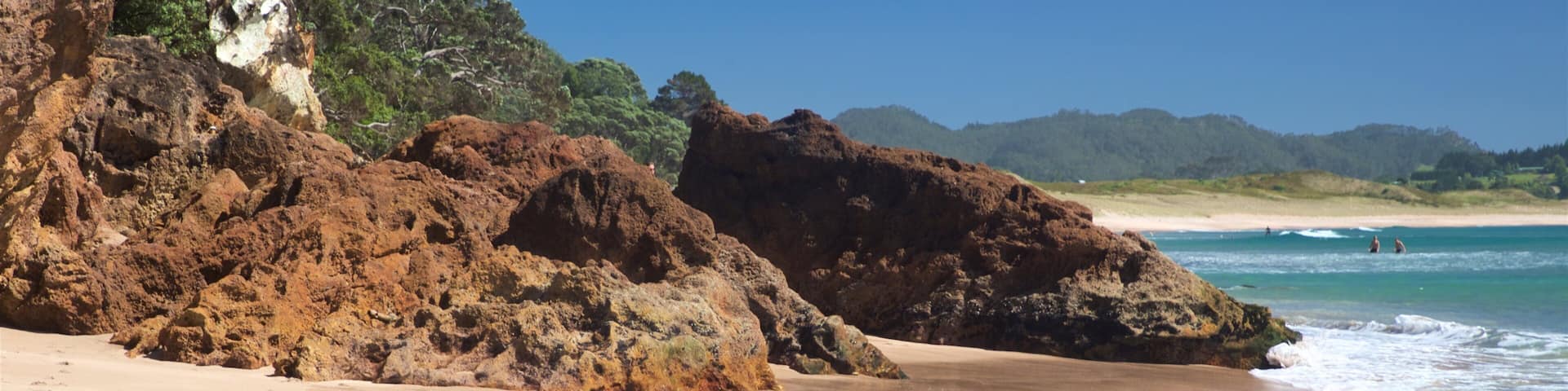 Hot Water Beach which includes rocky coastline, a sandy beach and general coastal views