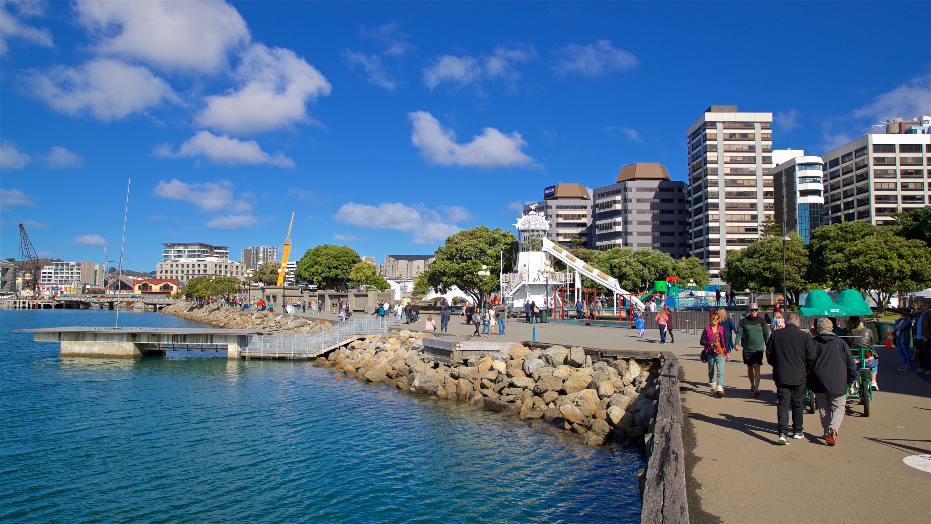Frank Kitts Park showing a bay or harbor as well as a small group of people