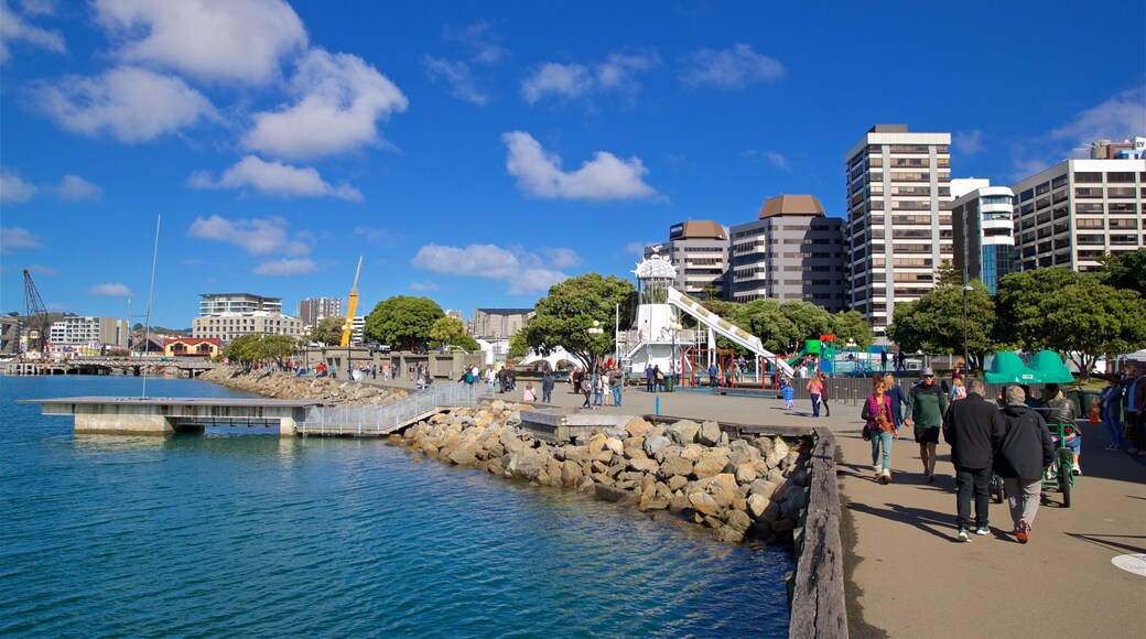 Frank Kitts Park showing a bay or harbor as well as a small group of people