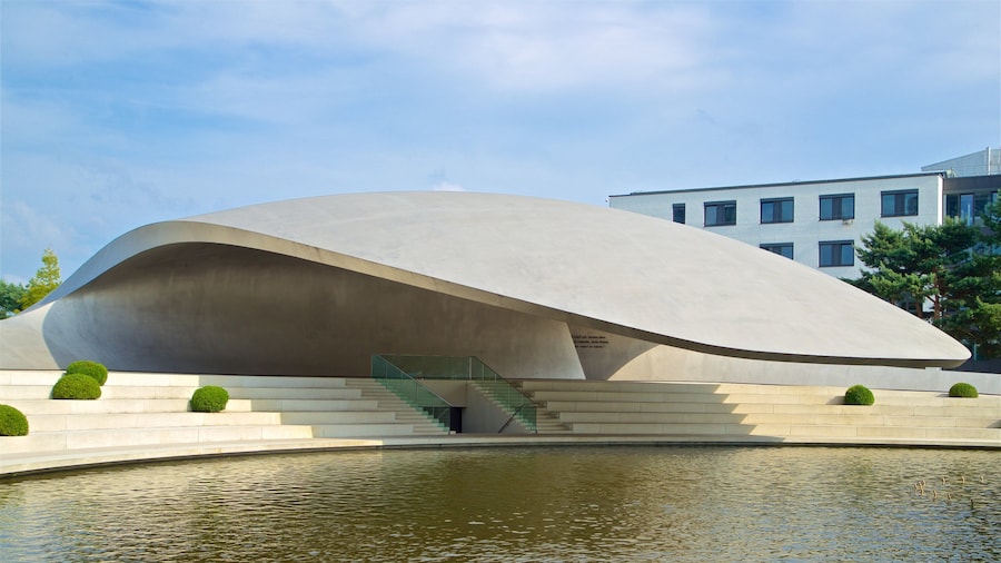 Volkswagen Autostadt Complex featuring a lake or waterhole and modern architecture