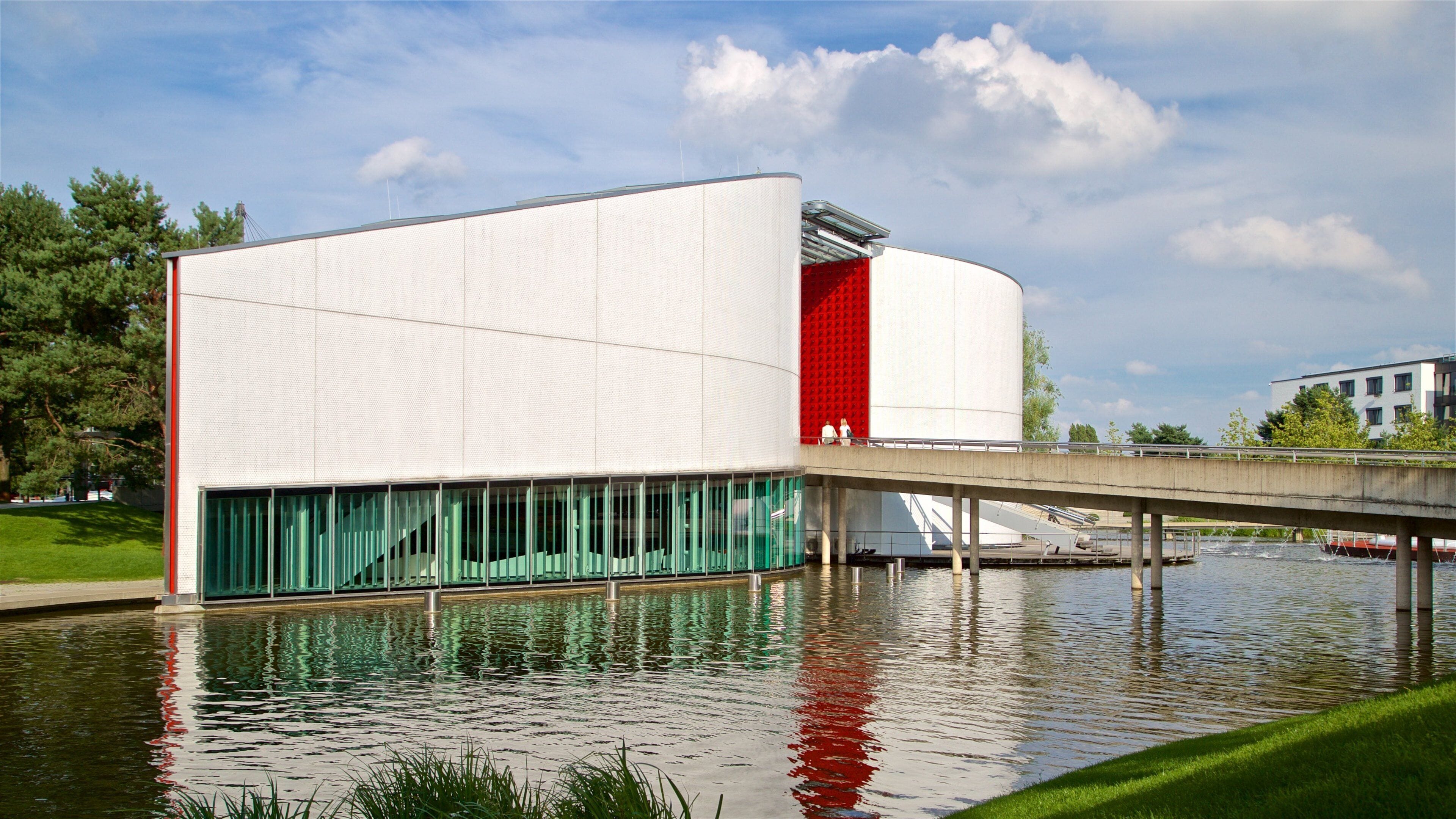 Volkswagen Autostadt Complex featuring a lake or waterhole, a bridge and modern architecture