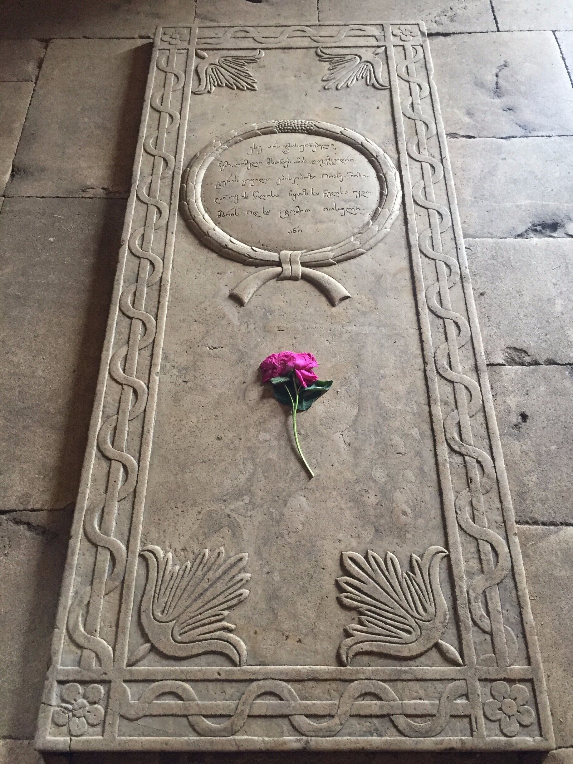 This UNESCO designated monastery in The Republic of Georgia was super busy despite the season and despite the rainy weather. There were people praying and monks chanting. The whole scene was magic.
And then our hearts broke just a little bit at seeing this single wilting rose placed on the grave of some king or saint or holy person.