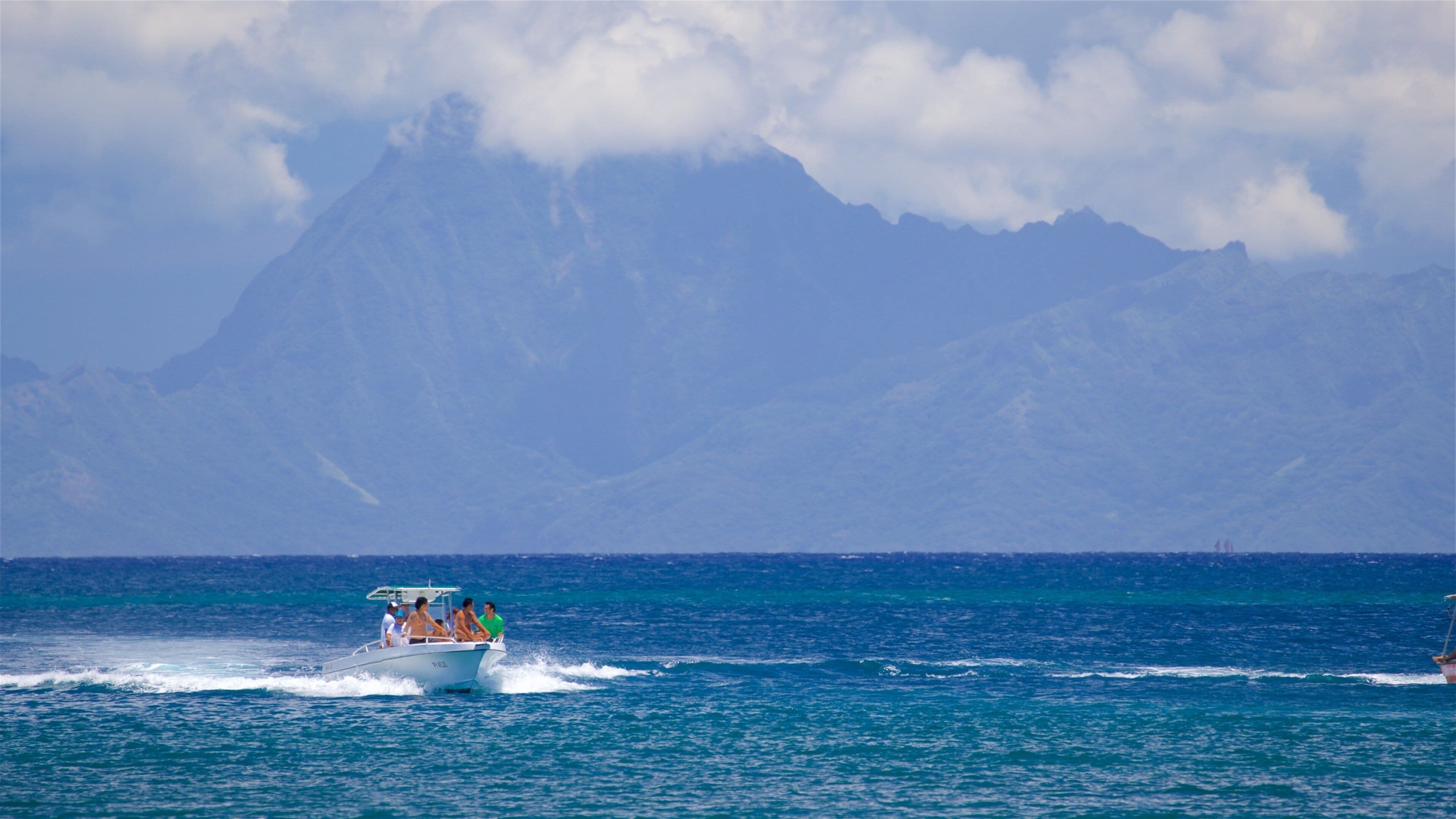 Black Sand Beach showing general coastal views and boating as well as a small group of people