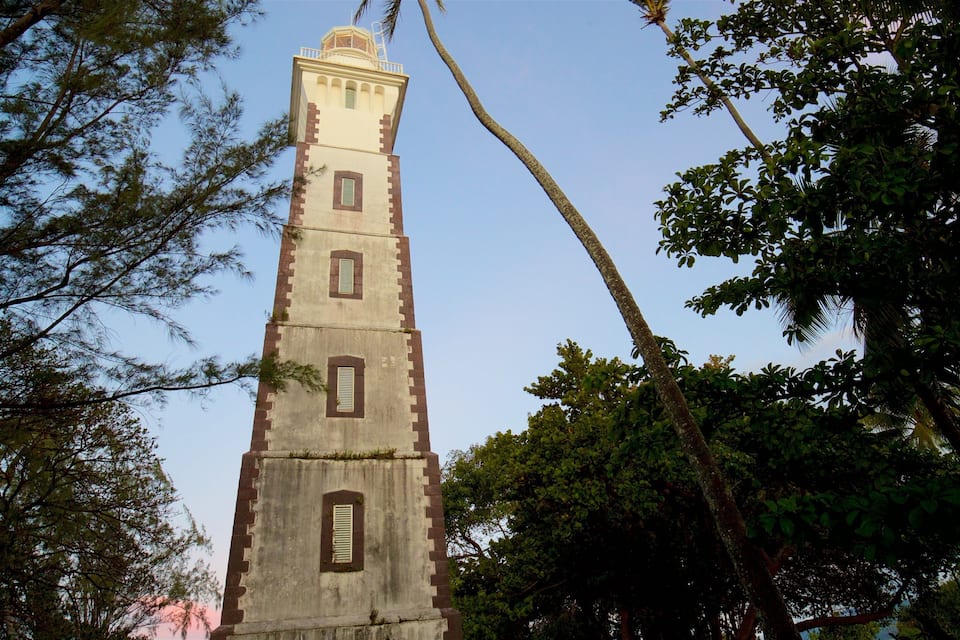 A tall tower with multiple windows, surrounded by trees.