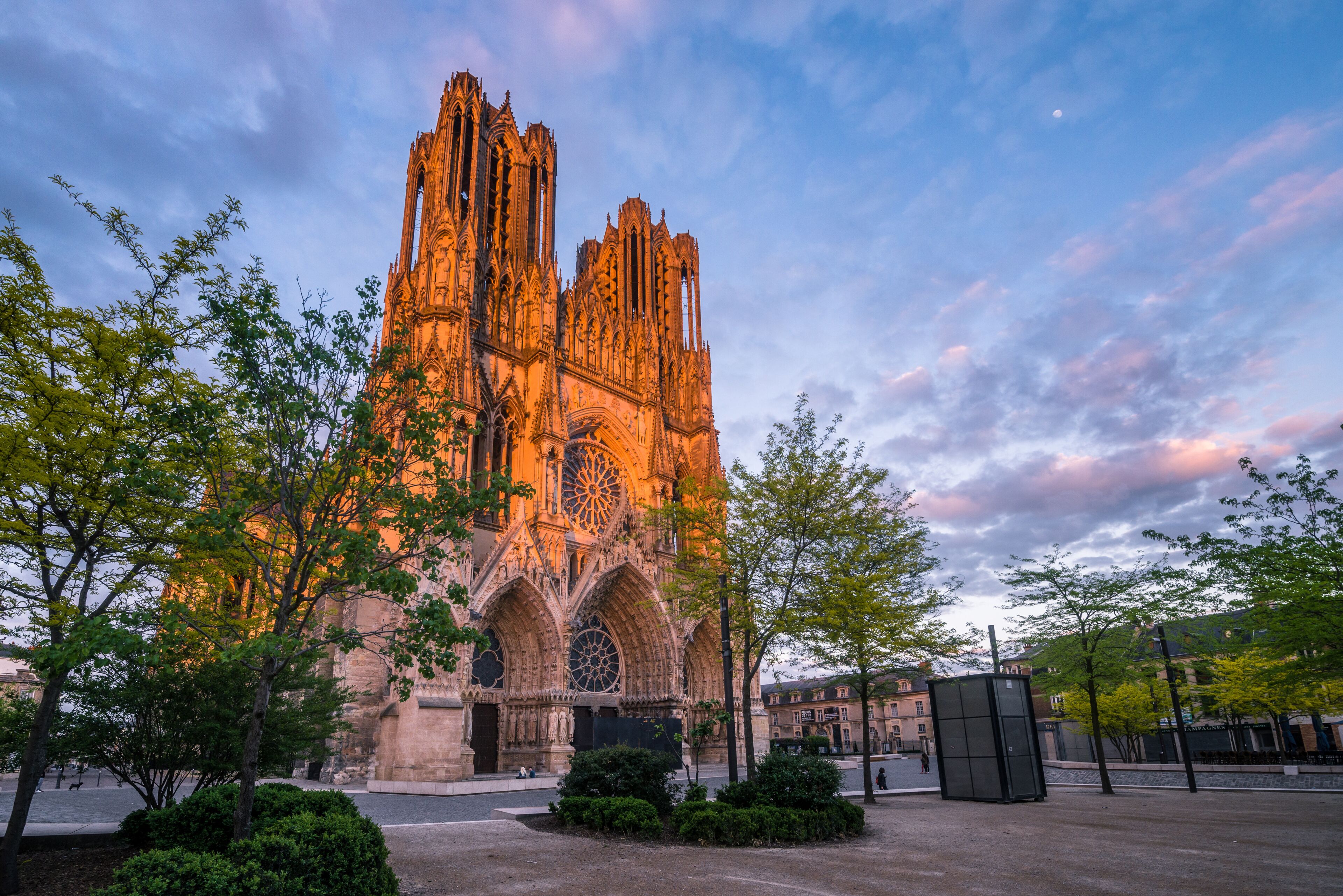 Warmly illuminated Reims cathedral in sunset light, France