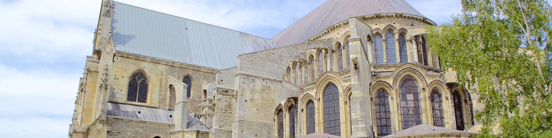 A historic cathedral with a large rose window and a pointed roof.