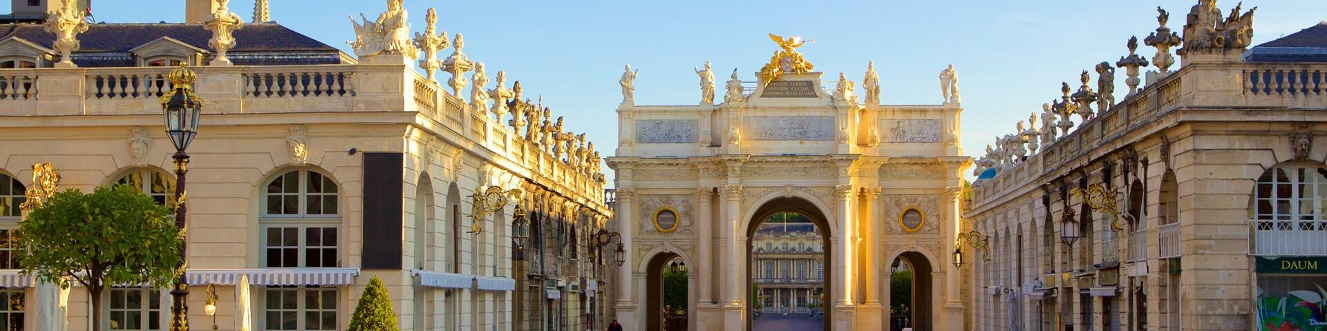 A grand entrance with ornate statues and a large archway.