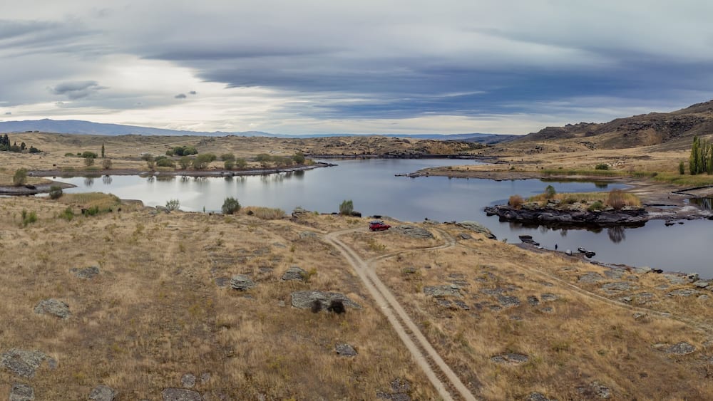 Dry farmland and Butchers Creek reservoir, Alexandra, Otago, New Zealand.